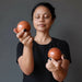 sheila of satin crystals holding 2 red jasper spheres
