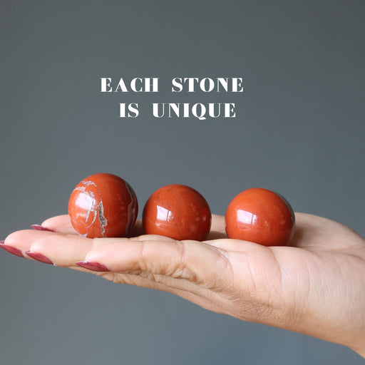 red jasper balls in hand