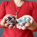 hands holding leopard jasper and dalmatian jasper tumbled stones