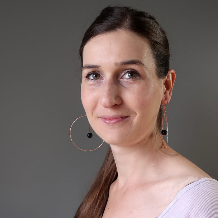lucia from satin crystals wearing jet stones in big copper hoop earrings