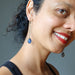 woman wearing blue kyanite dangle earrings