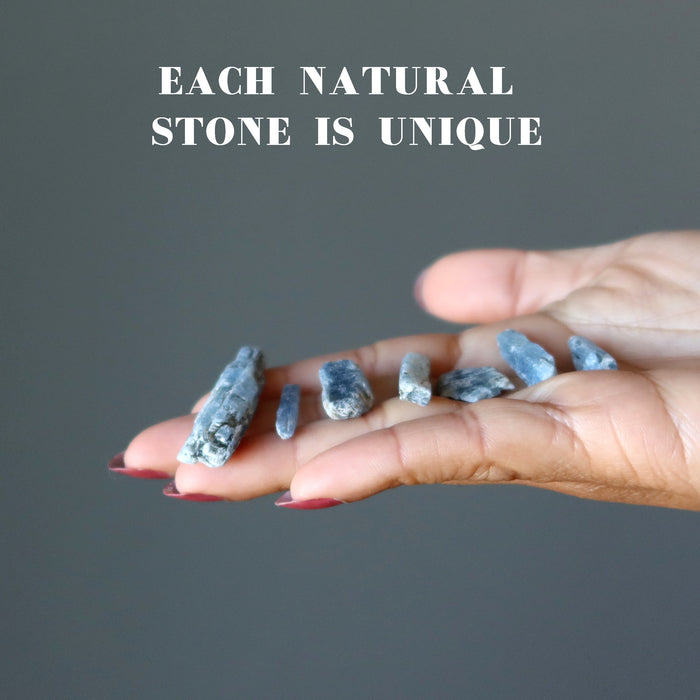raw blue kyanite stones in hand