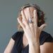 woman wearing blue kyanite oval in adjustable brass ring