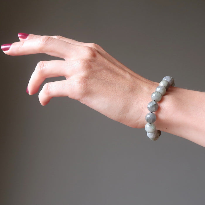hand wearing faceted labradorite beaded stretch bracelet