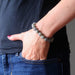 hands in jeans pocket wearing faceted labradorite beaded stretch bracelet