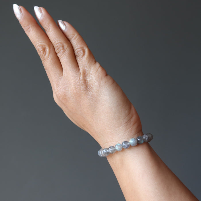 woman's hand wearing round labradorite beaded stretch bracelet