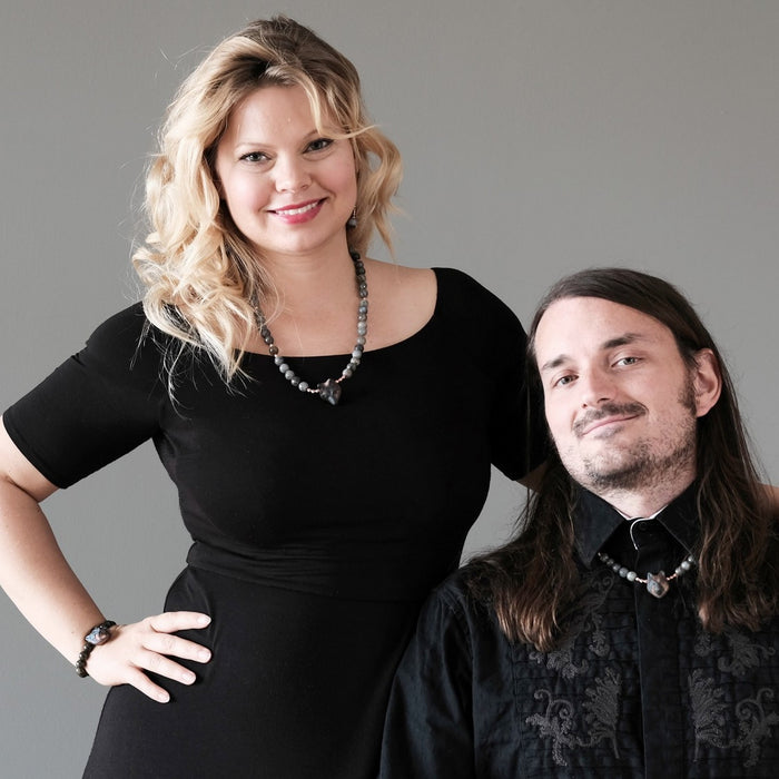 male and a female wearing labradorite wolf head necklaces