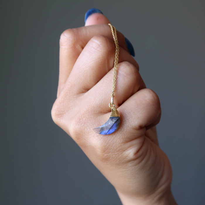 hand holding faceted labradorite crescent moon gold chain necklace