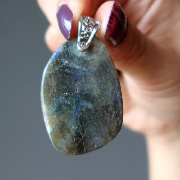 hand holding large labradorite pendant