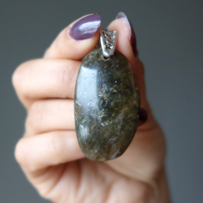 hand holding large labradorite pendant