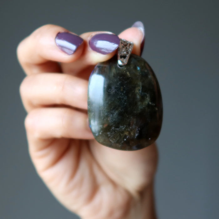 hand holding large labradorite pendant