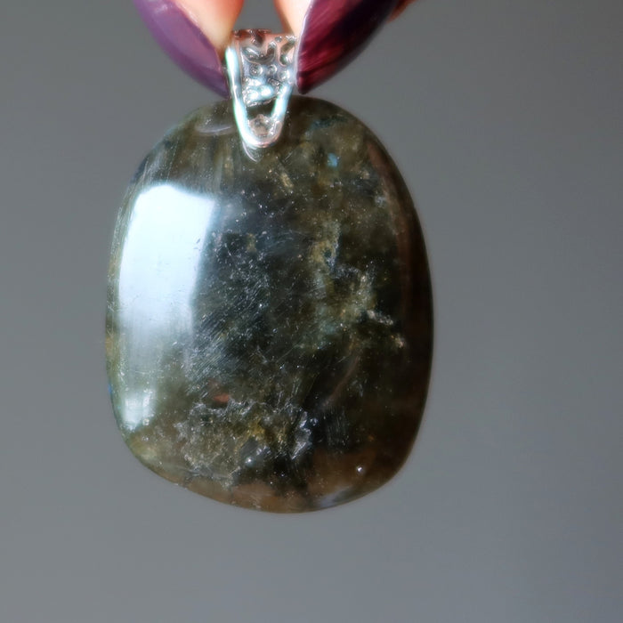hand holding large labradorite pendant