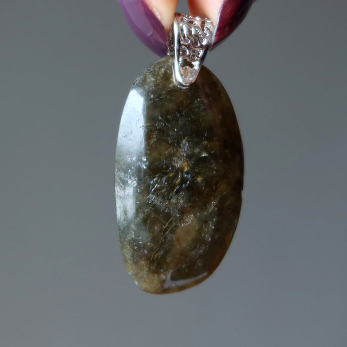 hand holding large labradorite pendant