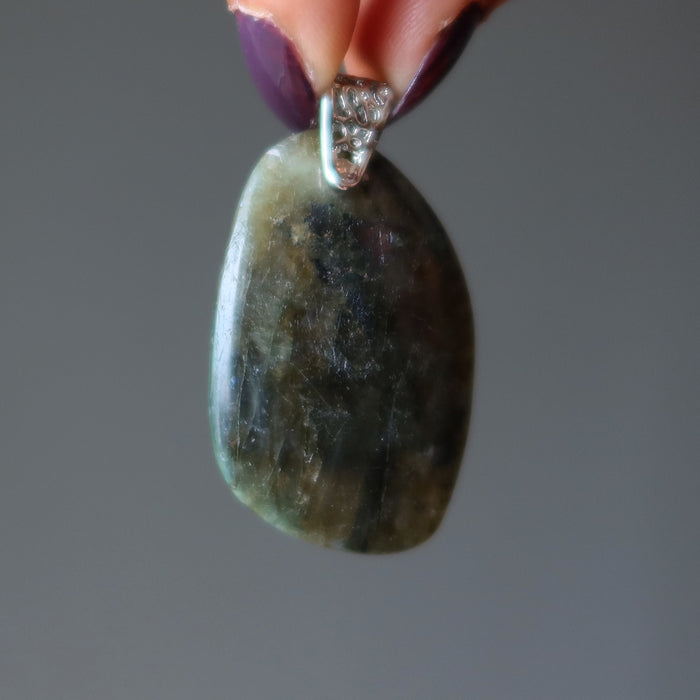 hand holding large labradorite pendant
