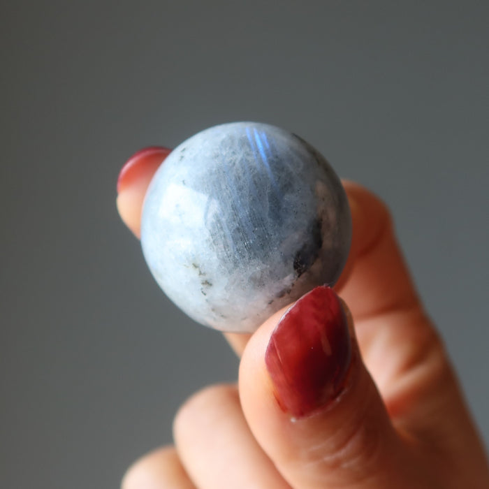 labradorite sphere in hand