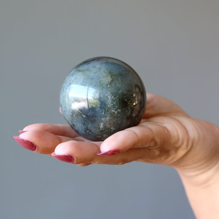 labradorite crystal ball in hand