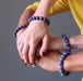 man and women's four hands intertwined wearing lapis lazuli stretch bracelets