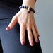 hand on leg wearing a lapis peace bullet stretch bracelet