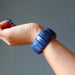 hand wearing a chunky lapis lazuli stretch cuff bracelet