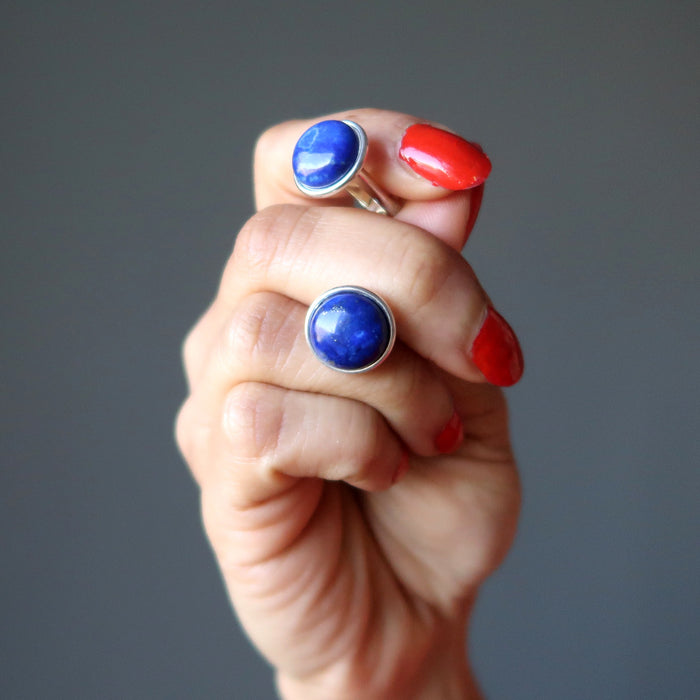 hand holding lapis lazuli silver cufflinks on french cuffs