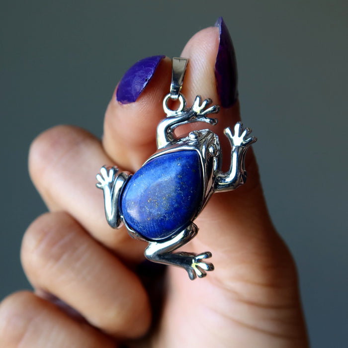 hand holding lapis frog pendant