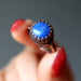 hand holding lapis round antique copper ring