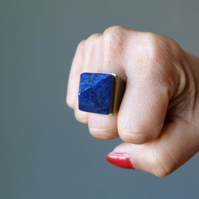 fist wearing lapis pyramid ring
