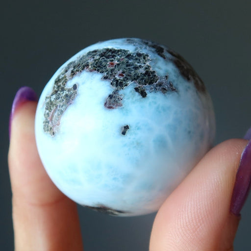 hand holding larimar sphere