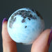 hand holding larimar sphere