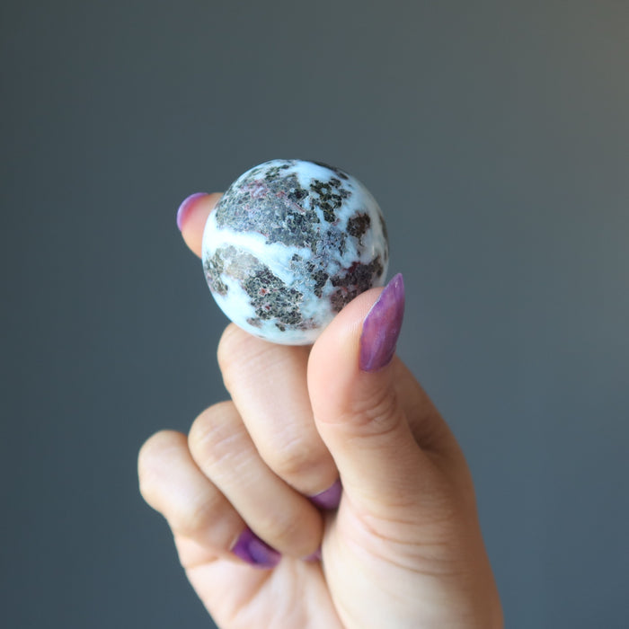 hand holding larimar sphere