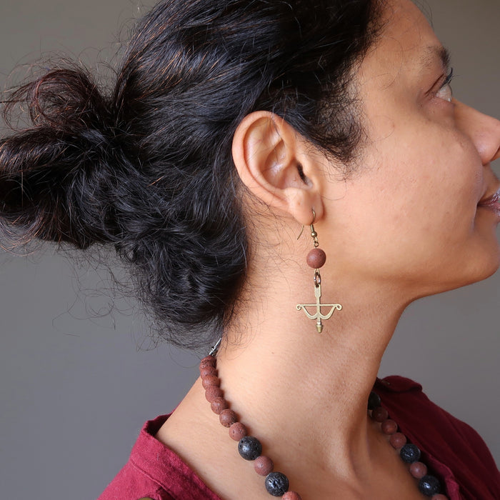 sheila of satin crystals wearing red lava bow and arrow archery dangle earrings