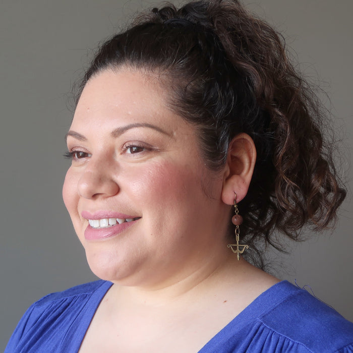 sotera of satin crystals wearing red lava bow and arrow archery dangle earrings