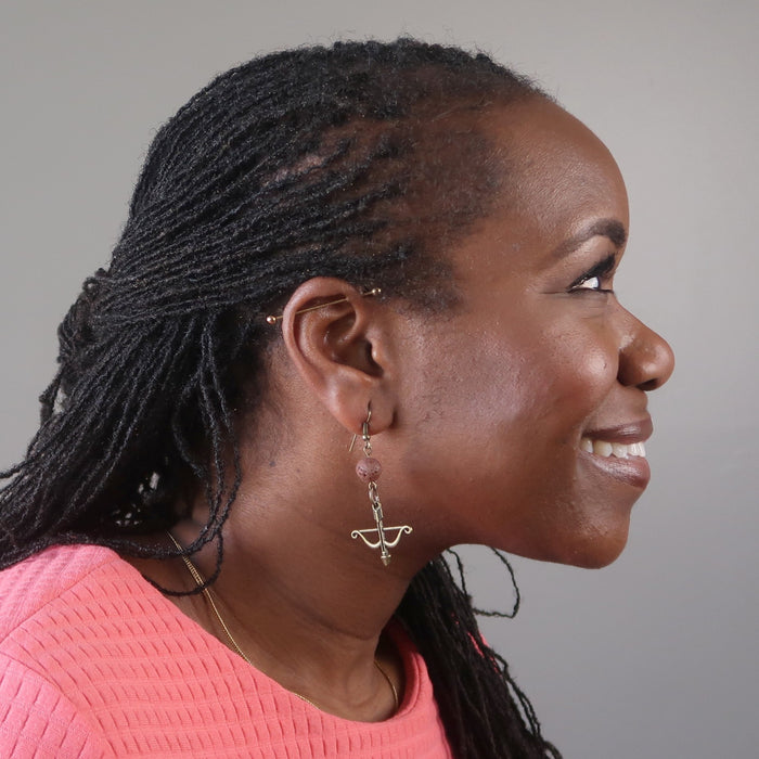 bridget of satin crystals wearing red lava bow and arrow archery dangle earrings