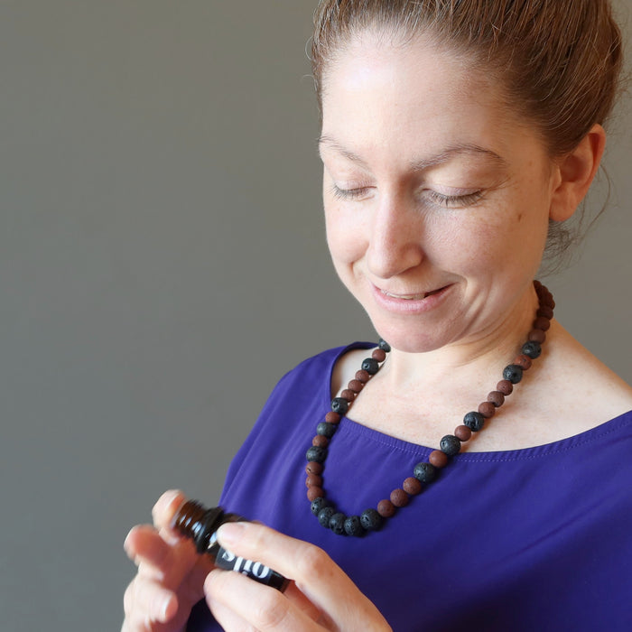woman wearing black and red lava necklace