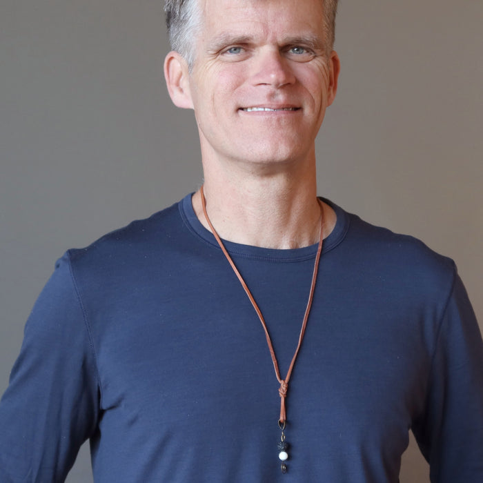man wearing lava howlite necklace