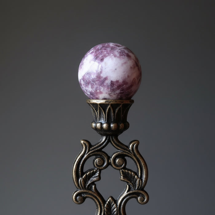 hand holding quartz lepidolite sphere