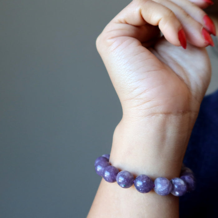 hand wearing purple lepidolite bracelet