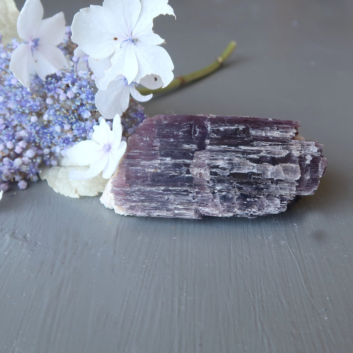 flowers and rough purple lepidolite on white quartz cluster