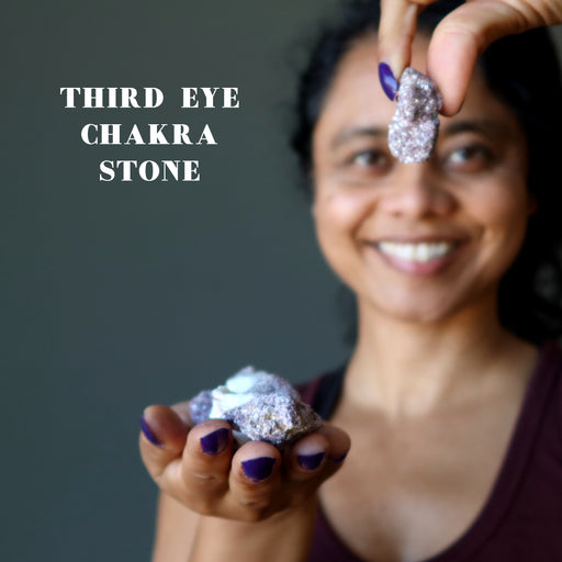 raw lepidolite stone at third eye chakra