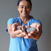 woman holding purple lepidolite tumbled stones