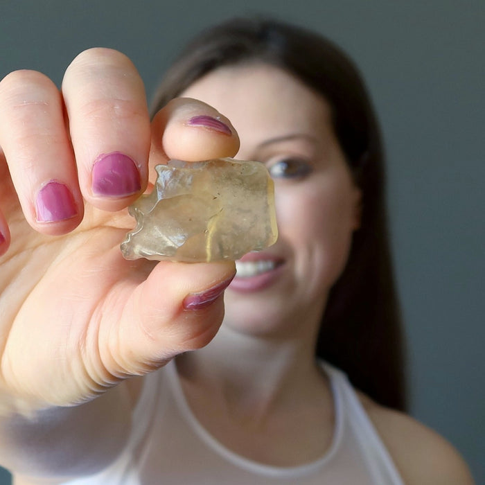 female holding libyan desert glass