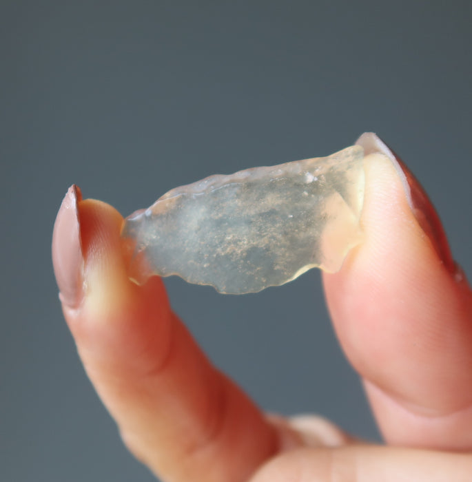 hand holding yellow libyan desert glass tektite