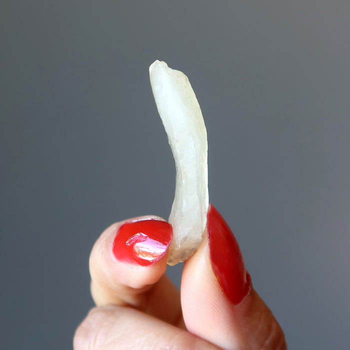 hand holding yellow libyan desert glass tektite