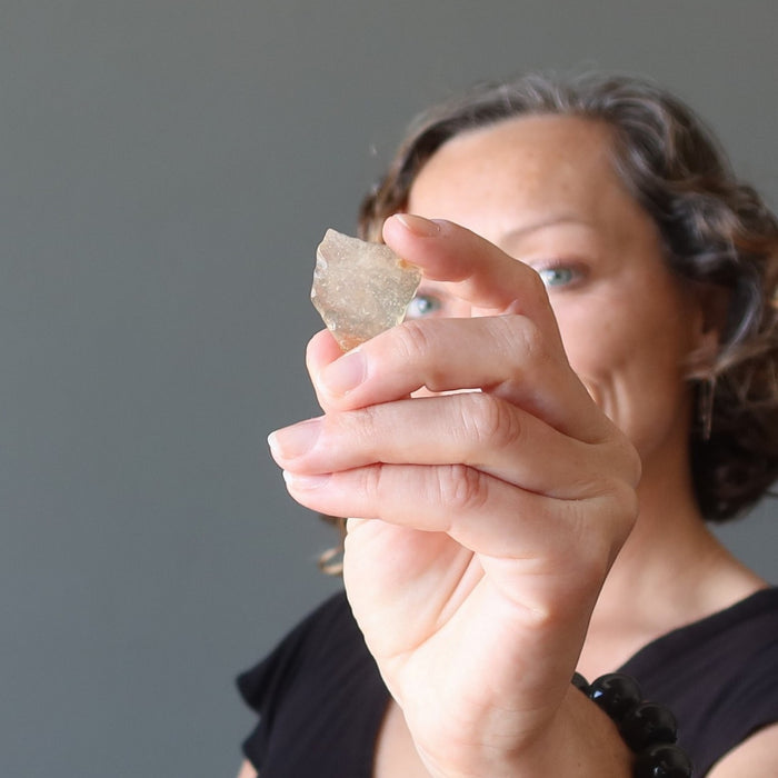 female holding libyan desert glass
