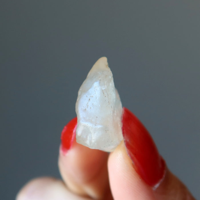 fingers holding up a libyan desert glass