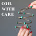 Sheila Satin pulling the green malachite memory wire bracelet and the phrase next to image reads "coil with care"