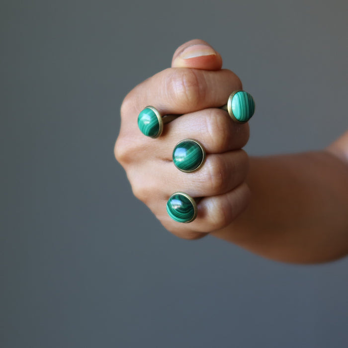 hands holding malachite cufflinks