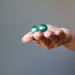 hands holding malachite cufflinks