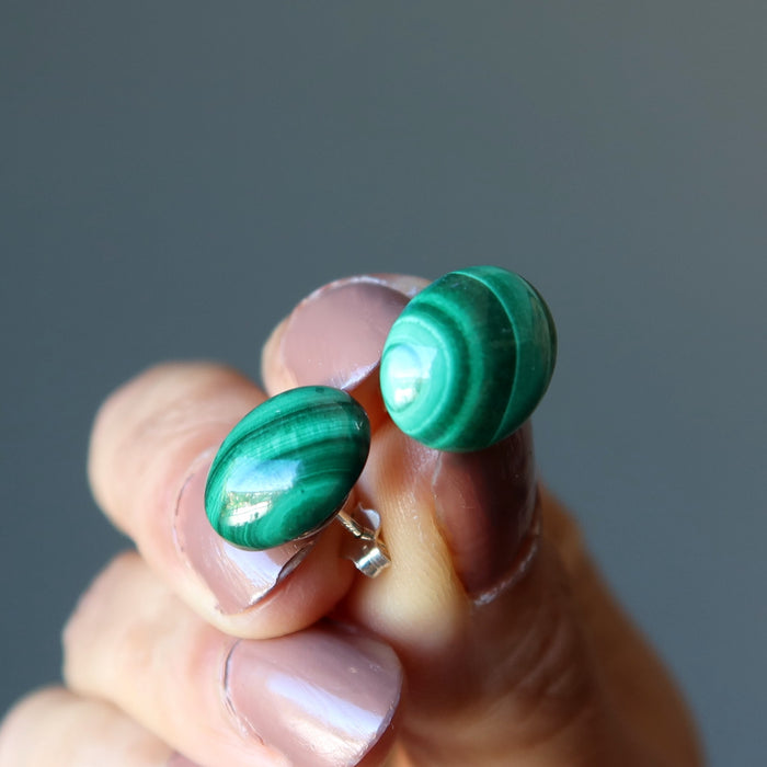 hand holding malachite stud earrings