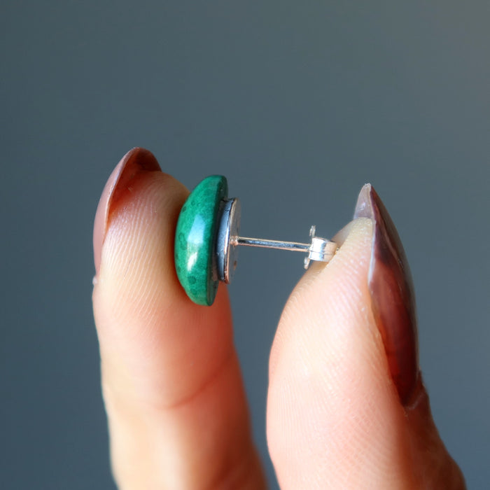 hand holding malachite stud earring
